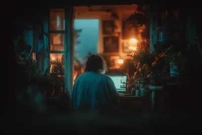 Illustration of a small business owner at a desk reviewing a website consultation document with pound sterling symbols